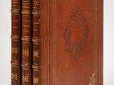 un ensemble de trois livres reliés en cuir, empilés les uns sur les autres
