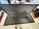 a suitcase that is sitting on a table with a pair of shoes