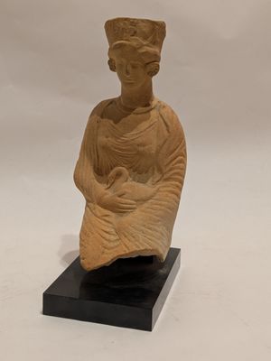 statue of a woman holding a baby on a black base