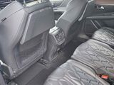 the back seats of a blue car with black seats in it
