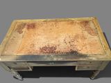 an old wooden table with a rusted surface on top