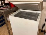 an open refrigerator sitting in a kitchen next to a counter