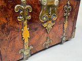 a wooden chest with brass hardware on it