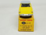 yellow toy car sitting on top of a yellow box on a white surface