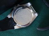 a watch that is laying on a green surface