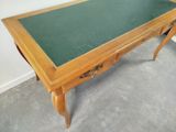 a table with a green top and a drawer underneath it
