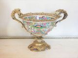 a large ornate bowl sitting on a table in a room