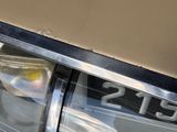 a close up of a car ' s headlight with the number twenty on it