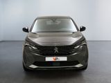 the front view of a grey car parked in a showroom