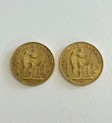 two gold coins with the image of a man and a woman on them