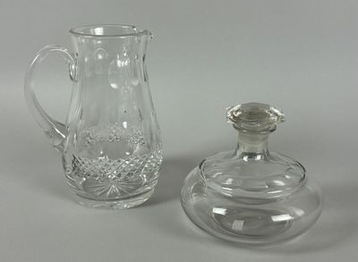 two glass vases and a glass bottle on a table