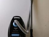 a black and silver vacuum and a black and white vacuum