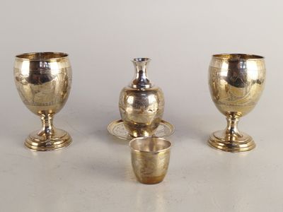 trois vases en argent posés les uns à côté des autres sur une table