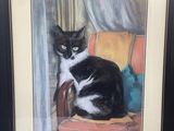 tableau représentant un chat noir et blanc assis sur une chaise rouge