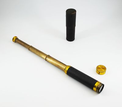 an image of a telescope with a black case next to it