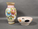 a vase and a bowl sitting next to each other on a table