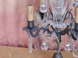 a crystal chandelier on a wooden table with a pink wall behind it