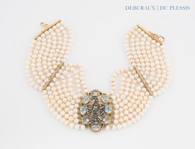 an image of a close up of a necklace with pearls and a broocher