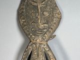 statue of a man with a cross on his head