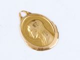 an image of a gold medal with a woman ' s face on it
