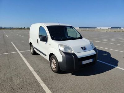 a small white van parked in a parking lot