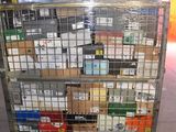 a metal cart with many boxes on it in a warehouse