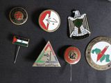 a lot of badges on a black table