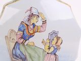 a plate with a picture of a woman and a child on it