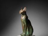 an egyptian bronze statue of a cat on a marble base