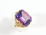 an image of a ring with a purple stone in it