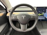 the interior of a tesla vehicle with a steering wheel and dashboard