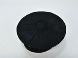 a black hat sitting on top of a white table