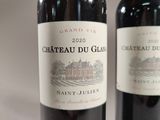 two bottles of wine sitting next to each other on a table