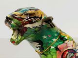 a statue of a cat with a colorful design on it ' s body