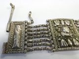 an image of a silver bracelet that has a picture of a woman on it