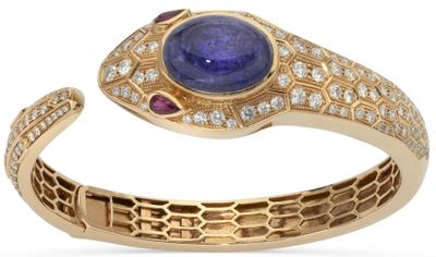 a close up of a ring with a blue stone and diamonds