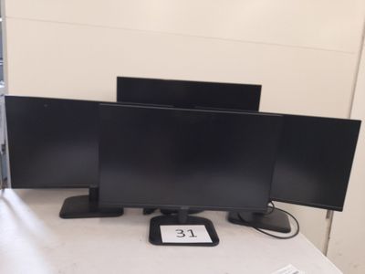 three monitors on a desk with a keyboard and mouse