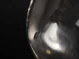 a close up of a metal object on a black background