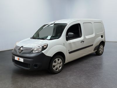 the white van is parked in a large room with a black floor