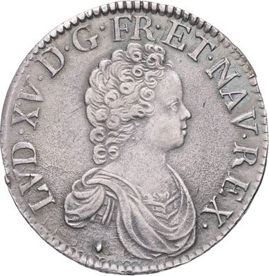 gros plan d'une pièce de monnaie sur laquelle figure un visage de femme