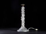 an image of a glass table lamp on a black surface