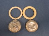pair of silver and gold earrings with a lion head on them