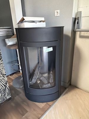 a fireplace in the corner of a room with a tv