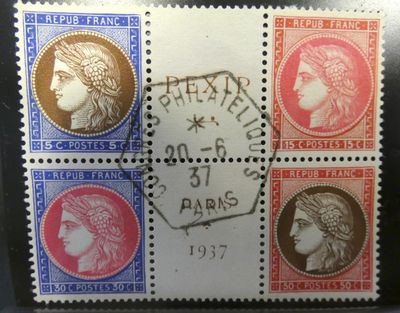 a close up of a stamp with four different faces on it