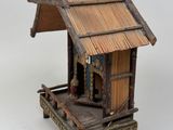 a small wooden structure with a thatched roof