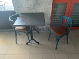 two chairs and a table on a tiled floor