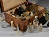 a wooden box filled with various bottles of perfume