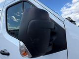 a white van parked in a parking lot with a red sticker on the side of the van