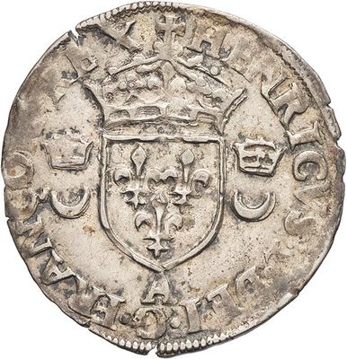 a close up of a silver coin with a crown on it