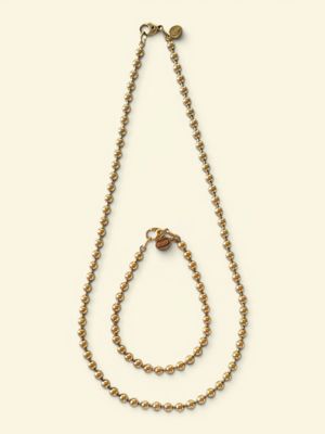 a close up of a necklace and a bracelet on a white background